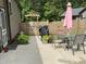 Outdoor patio with dining table, chairs, grill, and a view of the fenced yard at 105 Perry Ln, Zebulon, NC 27597