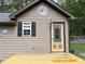 Exterior view of a shed featuring a window, door, and saw blade decor at 105 Perry Ln, Zebulon, NC 27597