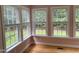 Bright room with multiple windows offering a view of the backyard, complemented by light hardwood floors at 105 Perry Ln, Zebulon, NC 27597