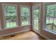 Bright sunroom with large windows offering serene views of the backyard and the surrounding nature at 105 Perry Ln, Zebulon, NC 27597