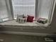 Close up of a window seat filled with decorative pillows and blankets at 105 Perry Ln, Zebulon, NC 27597