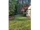 Large front yard with flowering trees and lush greenery at 105 Perry Ln, Zebulon, NC 27597