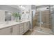 Bathroom featuring a double vanity, framed mirrors, and a tiled walk-in shower at 108 Hundred Oaks Ln, Holly Springs, NC 27540