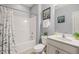 A bathroom with white fixtures, featuring a combination tub and shower, toilet, and single sink vanity at 108 Hundred Oaks Ln, Holly Springs, NC 27540