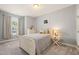 Light-filled bedroom with neutral decor, featuring a white bed frame, dresser and a window with natural light at 108 Hundred Oaks Ln, Holly Springs, NC 27540