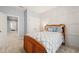Bright bedroom with light blue walls, white trim, a wooden bed and views to the doorway at 108 Hundred Oaks Ln, Holly Springs, NC 27540