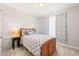 Charming bedroom with a wooden bed frame, stylish bedding, and a decorative accent wall for a cozy feel at 108 Hundred Oaks Ln, Holly Springs, NC 27540