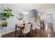 Chic dining room with modern lighting, hardwood floors, and neutral decor for elegant entertaining at 108 Hundred Oaks Ln, Holly Springs, NC 27540