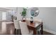 Dining room with hardwood floors, neutral walls, modern decor, and elegant lighting, perfect for gatherings at 108 Hundred Oaks Ln, Holly Springs, NC 27540