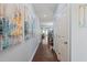 Long hallway with wood floors and light blue walls showcasing stylish decor and access to various rooms at 108 Hundred Oaks Ln, Holly Springs, NC 27540