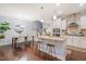 Bright, open kitchen with white cabinets, granite countertops, stainless steel appliances, and a central island at 108 Hundred Oaks Ln, Holly Springs, NC 27540