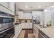 Modern kitchen featuring white cabinets, granite countertops, stainless steel appliances and stylish finishes at 108 Hundred Oaks Ln, Holly Springs, NC 27540