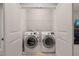 A well-lit laundry closet with a front-load washer and dryer at 108 Hundred Oaks Ln, Holly Springs, NC 27540