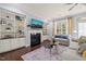 Cozy living room with a fireplace, built-in bookshelves, and natural light at 108 Hundred Oaks Ln, Holly Springs, NC 27540