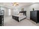 Inviting main bedroom features tray ceiling, plush carpet, and large dresser at 108 Hundred Oaks Ln, Holly Springs, NC 27540
