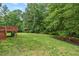 Expansive backyard featuring a deck, lush lawn, and mature trees for ultimate relaxation at 108 Teagan Ct, Chapel Hill, NC 27516