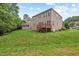 Large backyard featuring a deck, lawn, and mature trees at 108 Teagan Ct, Chapel Hill, NC 27516