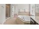 A bathroom showcases a soaking tub, a glass shower, and a walk-in closet at 108 Teagan Ct, Chapel Hill, NC 27516