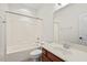 Bright bathroom featuring a shower-tub combo, neutral tiling, and a wood vanity at 108 Teagan Ct, Chapel Hill, NC 27516