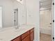 Bright bathroom featuring a shower-tub combo, neutral tiling, and a wood vanity at 108 Teagan Ct, Chapel Hill, NC 27516