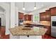 Modern kitchen with granite countertops, stainless steel appliances, and ample cabinet space at 108 Teagan Ct, Chapel Hill, NC 27516