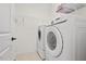 Laundry room with tile flooring, washer, dryer and wire shelving at 108 Teagan Ct, Chapel Hill, NC 27516