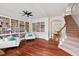 Spacious living room featuring hardwood floors, custom built-in bookshelves, and elegant seating at 108 Teagan Ct, Chapel Hill, NC 27516