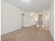 Spacious living room with neutral walls, carpet, and multiple doorways at 108 Teagan Ct, Chapel Hill, NC 27516