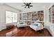 Bright living room featuring custom built-in bookshelves, hardwood floors, and elegant decor at 108 Teagan Ct, Chapel Hill, NC 27516