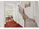 Staircase with carpeted steps and wood railing next to an archway into the living room at 108 Teagan Ct, Chapel Hill, NC 27516