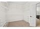 A walk-in closet features built-in shelving and a view into the bathroom at 108 Teagan Ct, Chapel Hill, NC 27516