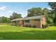 Well-maintained brick home featuring a lush green lawn and charming green window shutters at 10900 Poole Rd, Wendell, NC 27591