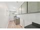 Utility room is equipped with ample storage cabinets and counter space with wood-look floors at 10900 Poole Rd, Wendell, NC 27591