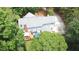 Birds eye view of home with backyard deck, driveway, and surrounded by lush, mature trees at 12037 Deer Run, Raleigh, NC 27614