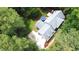 An aerial view of the home features the gray roof, mature trees, and a concrete driveway at 12037 Deer Run, Raleigh, NC 27614