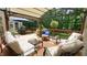 Outdoor living space on a back deck with cushioned seating and a shady canopy at 12037 Deer Run, Raleigh, NC 27614