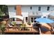 An elevated wood deck is shaded by an awning and umbrella, and furnished for outdoor dining and lounging at 12037 Deer Run, Raleigh, NC 27614