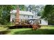 Expansive backyard featuring a multi-level deck with patio seating, barbecue grill, and lush landscaping at 12037 Deer Run, Raleigh, NC 27614