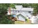 Backyard view featuring a large deck with seating and grill, set against a backdrop of mature trees at 12037 Deer Run, Raleigh, NC 27614