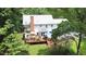Aerial view of a backyard featuring a deck, mature trees, and plenty of space for outdoor activities at 12037 Deer Run, Raleigh, NC 27614