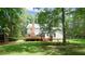 Expansive backyard featuring a multi-level deck with seating and lush landscaping creating a private outdoor space at 12037 Deer Run, Raleigh, NC 27614