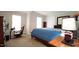 Spacious bedroom with two windows, a cozy bed, and a game chair at 12037 Deer Run, Raleigh, NC 27614