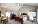Inviting bedroom featuring a king-size bed, ample natural light, and classic decor at 12037 Deer Run, Raleigh, NC 27614