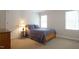 Cozy bedroom with carpet, neutral walls, two windows and a door to the left at 12037 Deer Run, Raleigh, NC 27614