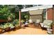 Outdoor deck featuring a covered lounge area with comfortable seating surrounded by greenery at 12037 Deer Run, Raleigh, NC 27614