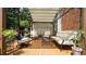 Backyard deck with covered lounge showcasing cushioned seating and views of surrounding landscaping at 12037 Deer Run, Raleigh, NC 27614