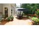The spacious wooden deck features an outdoor dining set, complemented by lush potted plants and a large umbrella at 12037 Deer Run, Raleigh, NC 27614
