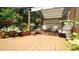 Outdoor deck with covered seating and lush potted plants creating a tranquil relaxation space at 12037 Deer Run, Raleigh, NC 27614