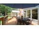 Outdoor deck featuring a dining area with an umbrella, flowers, seating, and a covered seating area for relaxing at 12037 Deer Run, Raleigh, NC 27614