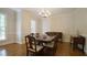 Elegant dining room with a wood table, chandelier, and hardwood flooring at 12037 Deer Run, Raleigh, NC 27614